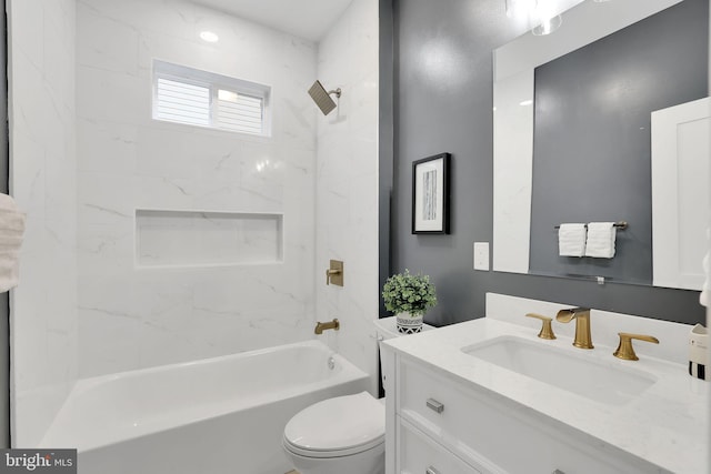 full bathroom with tiled shower / bath combo, vanity, and toilet