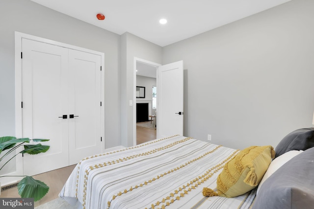 bedroom with a closet and hardwood / wood-style flooring