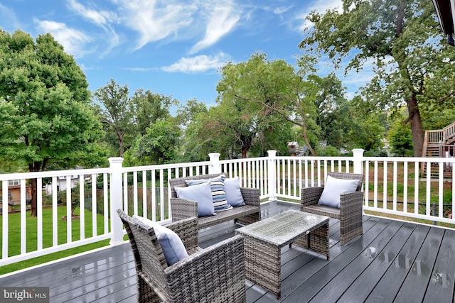 deck featuring a lawn and an outdoor living space