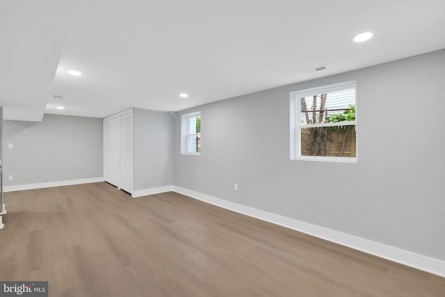 basement with hardwood / wood-style flooring