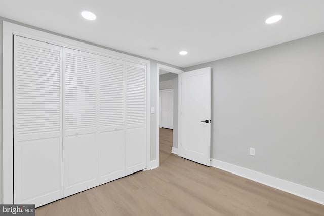 unfurnished bedroom featuring a closet and light hardwood / wood-style floors