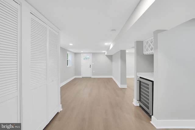 interior space with wine cooler and light wood-type flooring