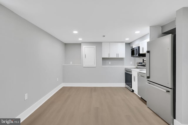 kitchen with white cabinetry, light hardwood / wood-style floors, and appliances with stainless steel finishes