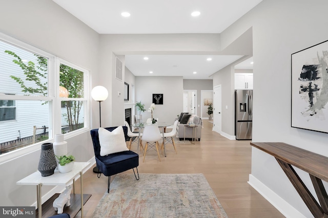 living area with light hardwood / wood-style flooring