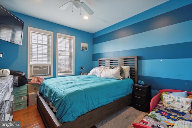 bedroom with hardwood / wood-style floors and ceiling fan