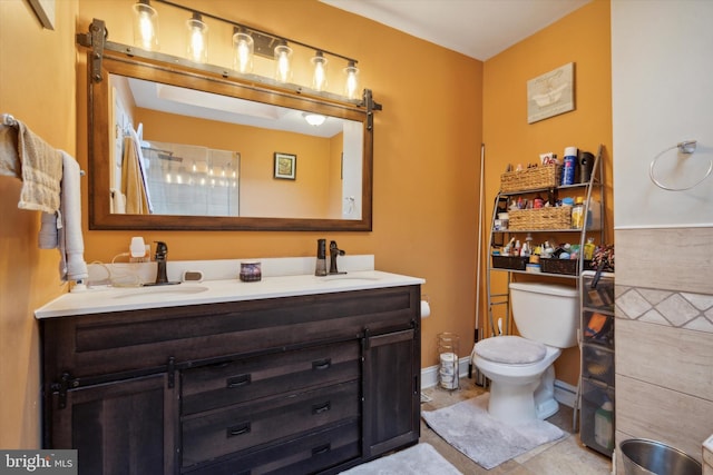 bathroom with vanity, toilet, and tile patterned floors