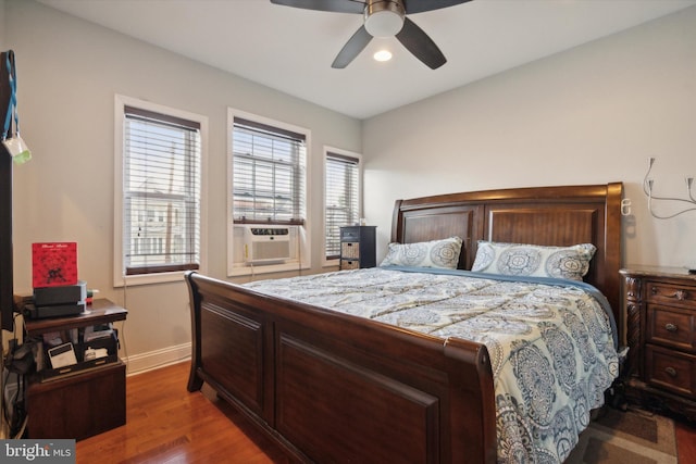 bedroom with wood-type flooring, cooling unit, and ceiling fan