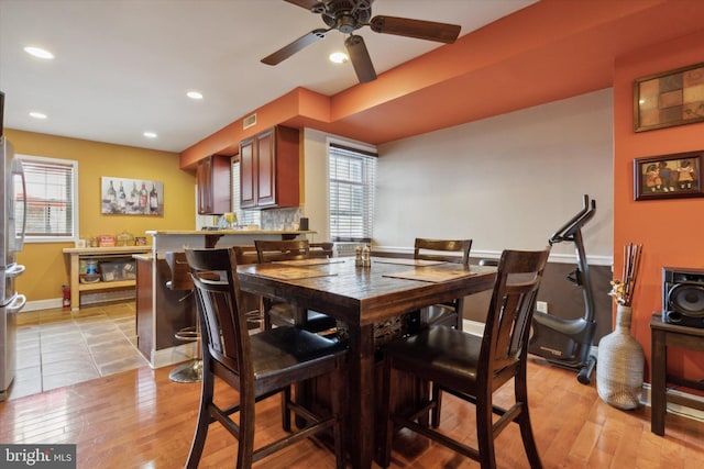 dining area featuring ceiling fan and light wood-type flooring