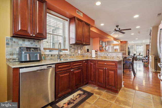 kitchen with kitchen peninsula, ceiling fan, plenty of natural light, and stainless steel dishwasher