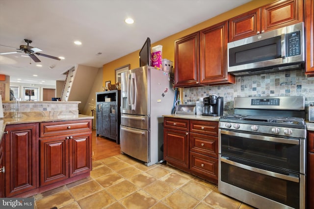 kitchen with ceiling fan, stainless steel appliances, backsplash, and light stone counters