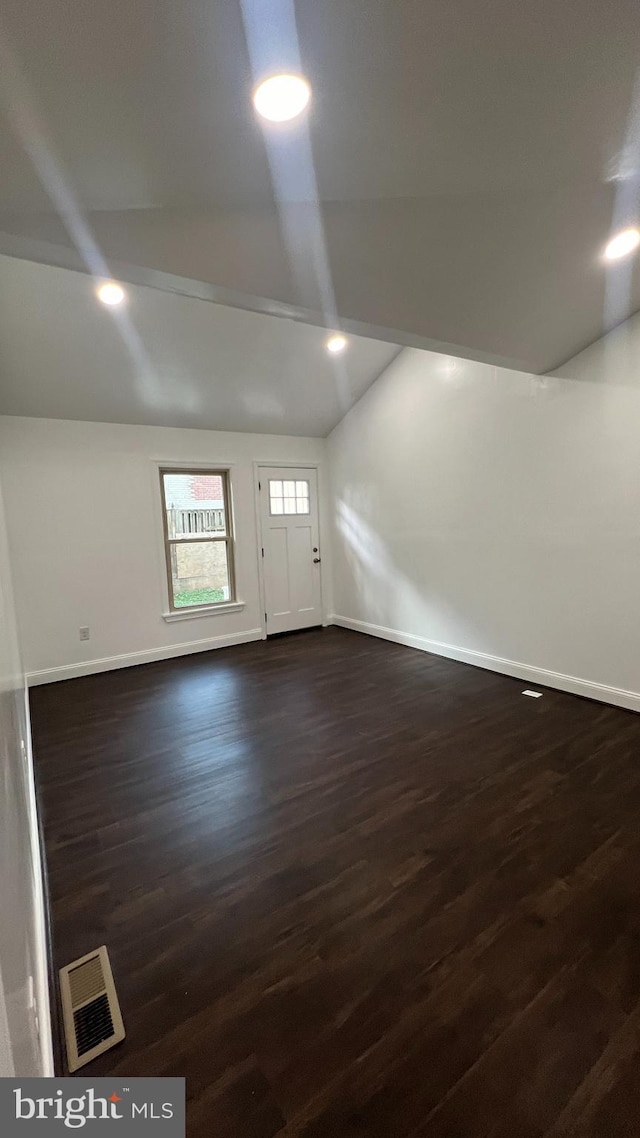 interior space with lofted ceiling and dark hardwood / wood-style floors