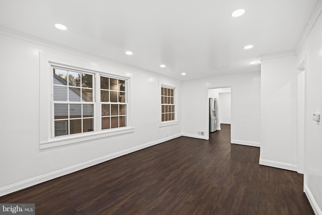 empty room featuring dark hardwood / wood-style floors and crown molding