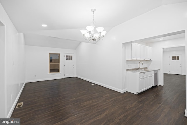 interior space featuring lofted ceiling, dark hardwood / wood-style floors, sink, and a notable chandelier