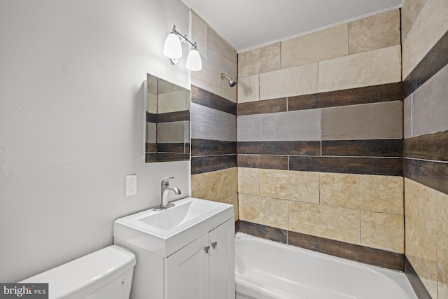 full bathroom featuring vanity, tiled shower / bath, and toilet