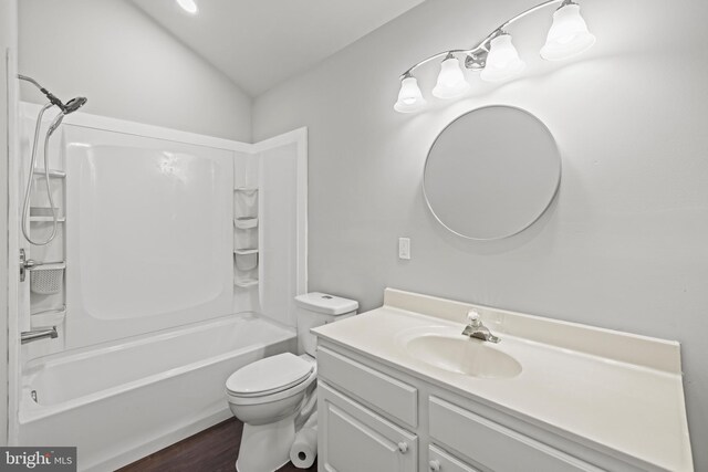 7213 Tyler Ave, Falls Church, VA 22042 - bathroom with toilet, wood finished floors, washtub / shower combination, vanity, and lofted ceiling