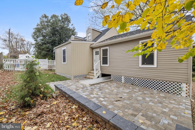 back of property with a patio