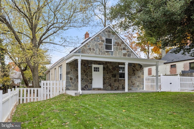 7213 Tyler Ave, Falls Church, VA 22042 - rear view of house featuring a chimney, stone siding, fence private yard, and a lawn