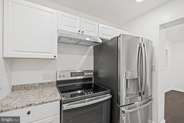 kitchen with white cabinets, light stone countertops, stainless steel appliances, and dark hardwood / wood-style flooring