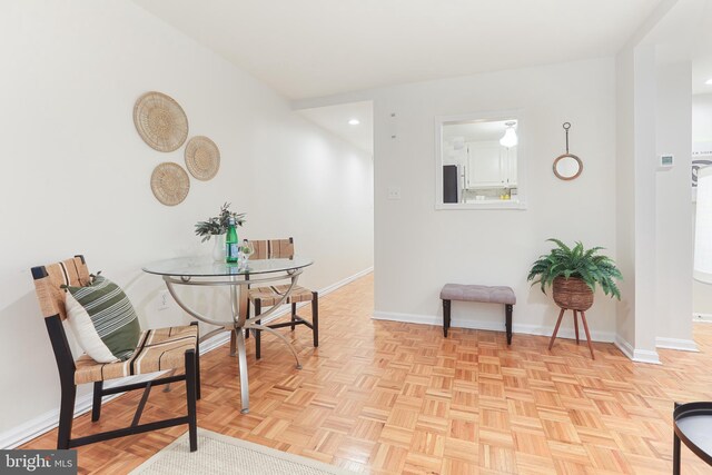 dining space with light parquet flooring