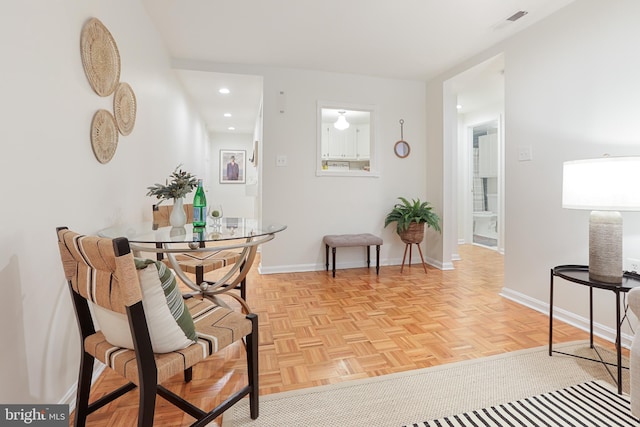 dining space featuring light parquet floors