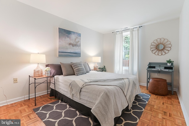 bedroom with light parquet floors