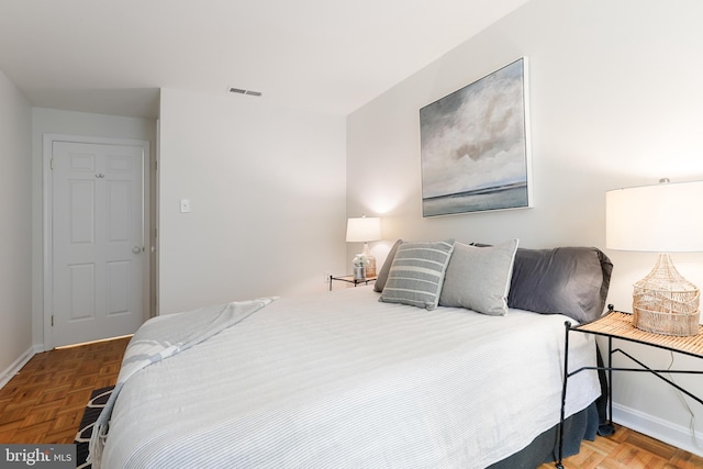 bedroom featuring parquet flooring