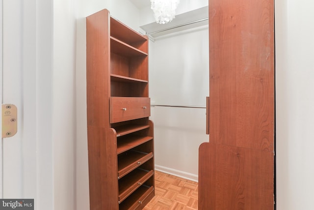 spacious closet with light parquet floors