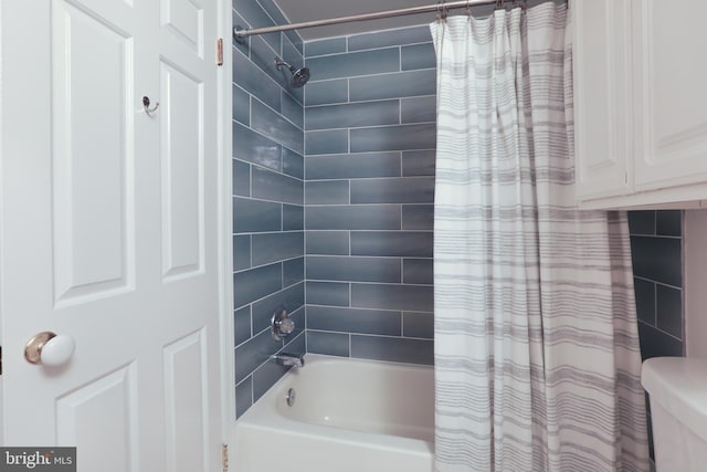 bathroom featuring shower / bathtub combination with curtain and toilet