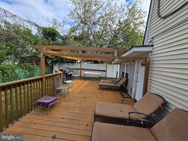 wooden terrace featuring a pergola and a grill