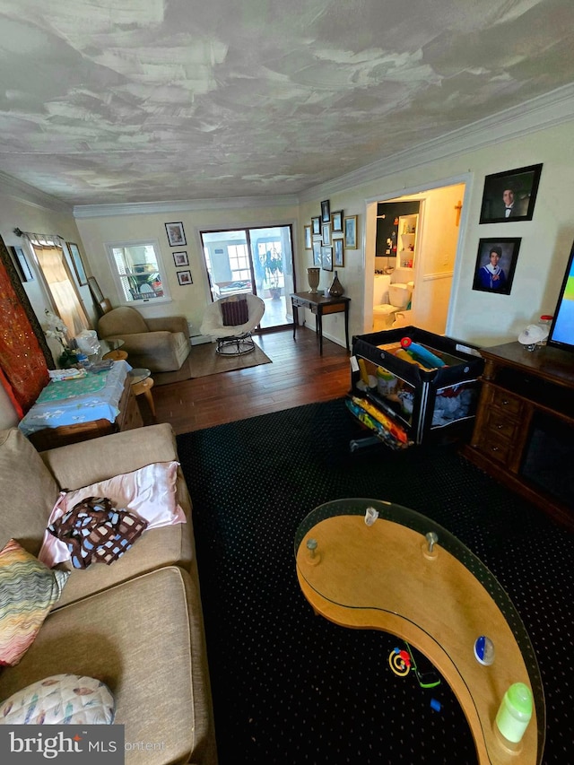 living room featuring a textured ceiling, ornamental molding, and hardwood / wood-style flooring