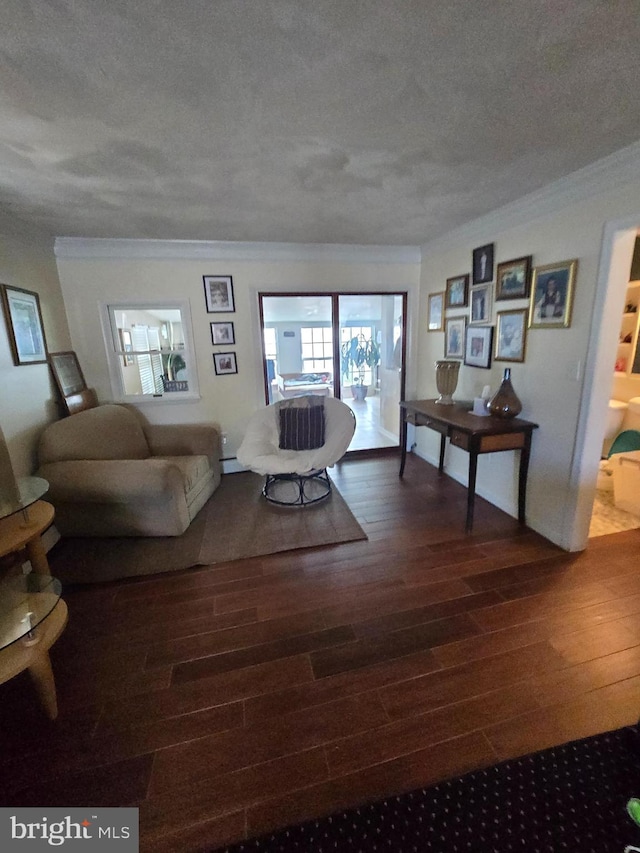 living room with a textured ceiling, crown molding, and hardwood / wood-style floors