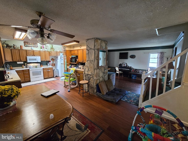 living room with light wood-type flooring, ceiling fan, and a textured ceiling