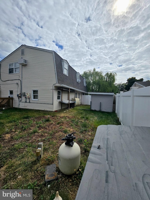 view of yard featuring a shed and a patio area