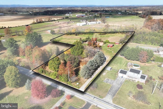 birds eye view of property with a rural view