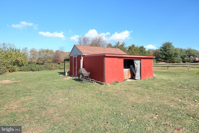 view of outbuilding featuring a lawn