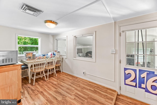 dining space featuring light wood-type flooring