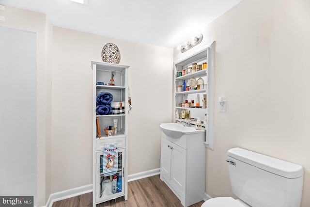 bathroom featuring hardwood / wood-style floors, vanity, and toilet