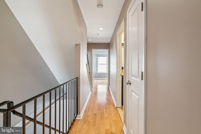 corridor with light hardwood / wood-style flooring