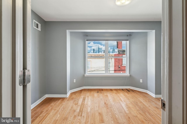 spare room featuring light wood-type flooring