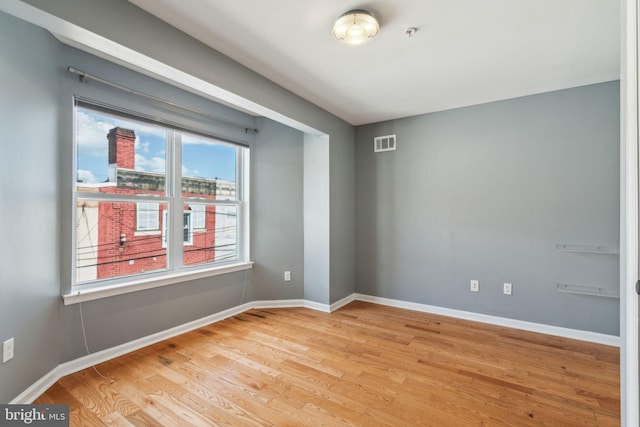 unfurnished room with light hardwood / wood-style flooring