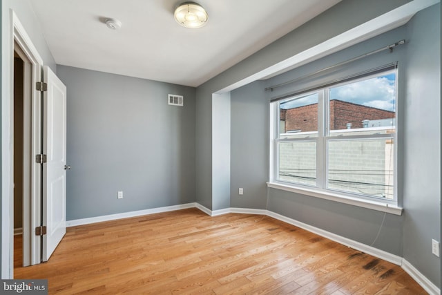 unfurnished bedroom featuring light hardwood / wood-style flooring and multiple windows