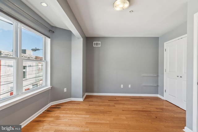 interior space with light hardwood / wood-style flooring and multiple windows