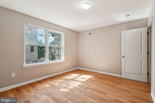 spare room featuring light hardwood / wood-style floors