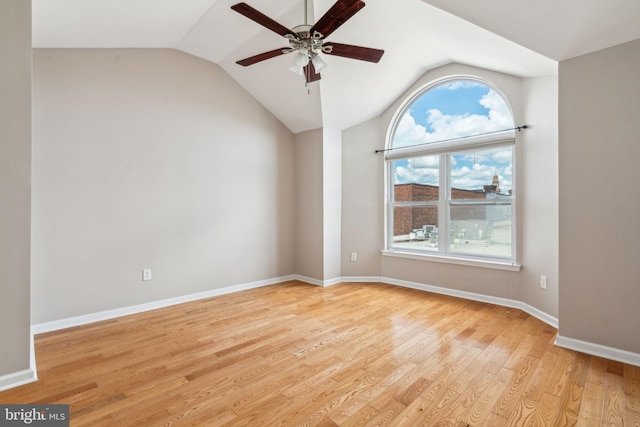 unfurnished room featuring ceiling fan, light wood-type flooring, and vaulted ceiling