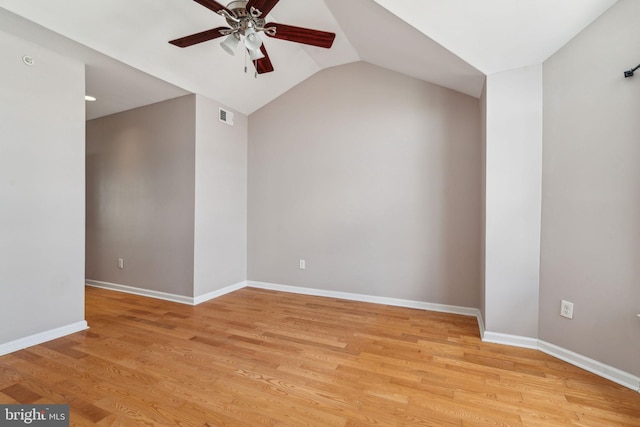 spare room featuring light hardwood / wood-style floors, ceiling fan, and vaulted ceiling