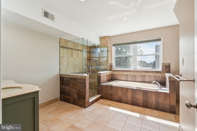 bathroom featuring vanity, shower with separate bathtub, and tile patterned flooring