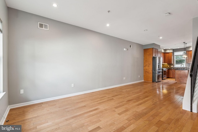 unfurnished living room with light hardwood / wood-style flooring