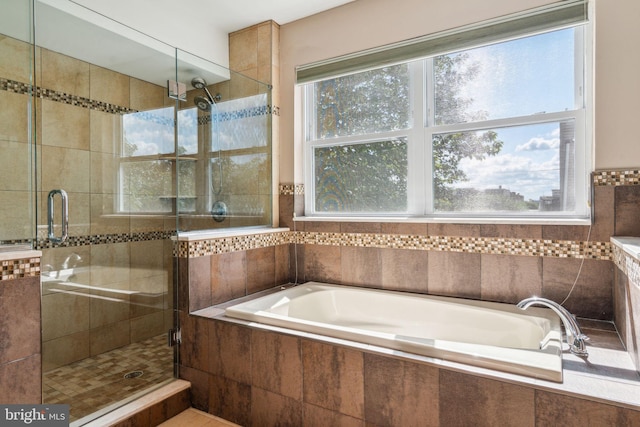 bathroom featuring separate shower and tub and a wealth of natural light