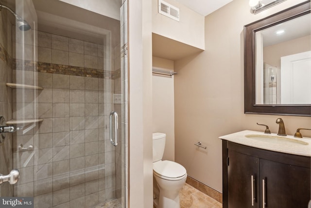 bathroom with vanity, a shower with shower door, toilet, and tile patterned flooring