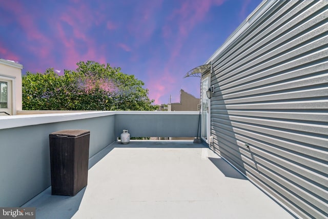 patio terrace at dusk with a balcony